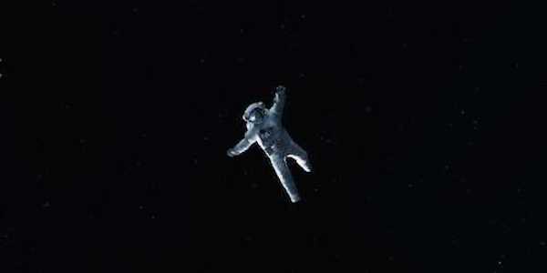 A lone astronaut floats out into space distraught